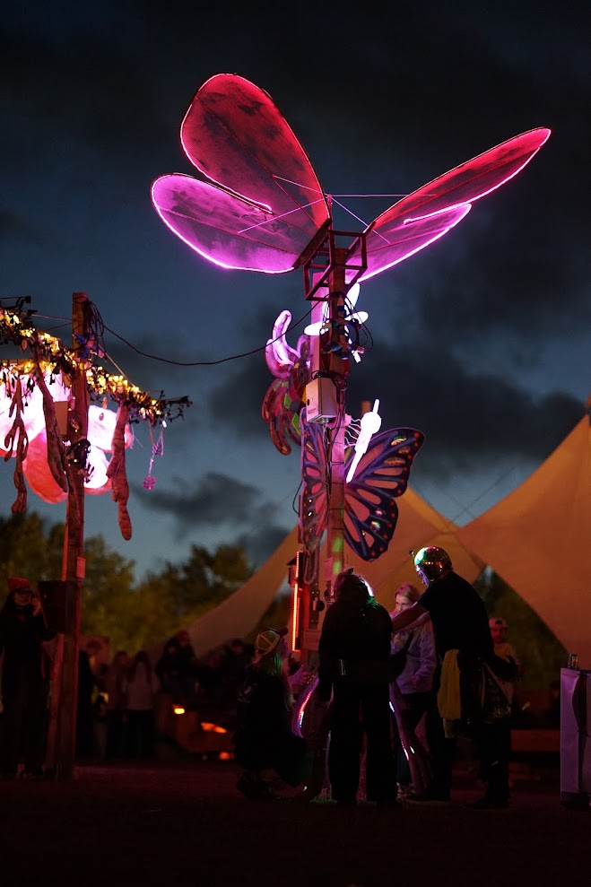 Glowing pink butterfly wings at Roskilde Festival 2026